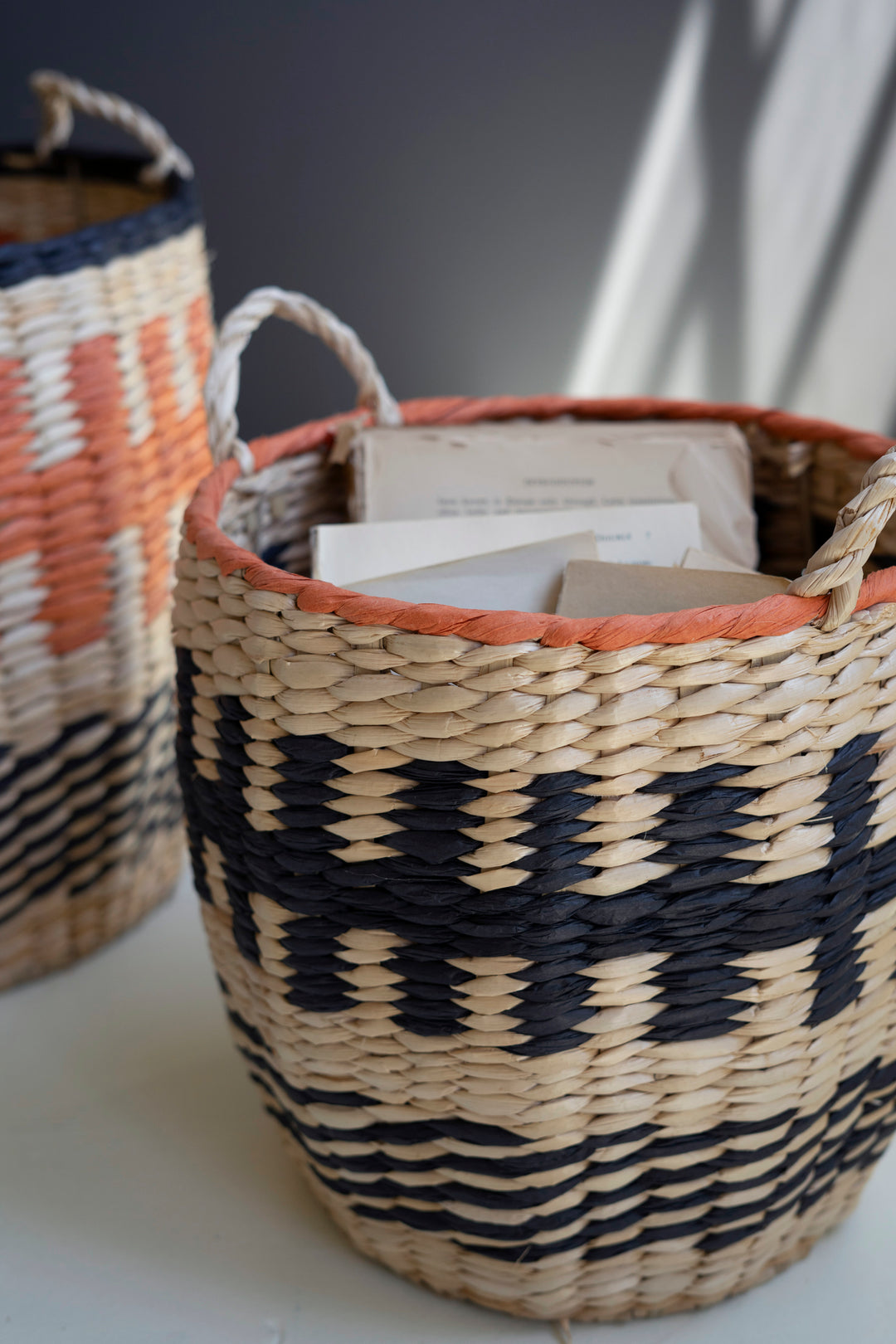 Set Of 2 Woven Orange And Black Seagrass Baskets