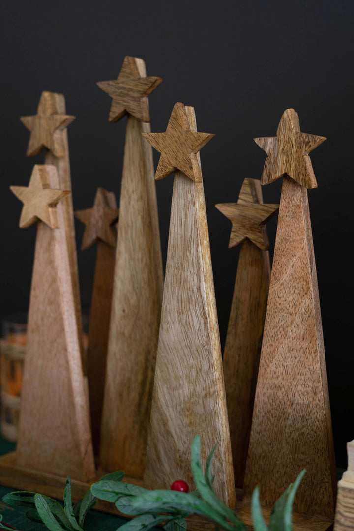 Seven Wooden Christmas Trees On A Base